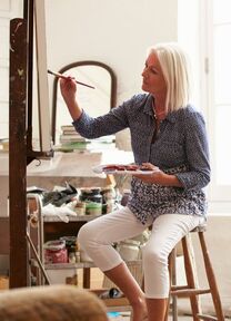 woman painting and wondering how to price her art