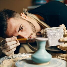 Artist creating pottery confident he knows how to price his art